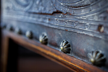 Decorative carnations on the back of an antique chair with genuine leather. Retro close-up