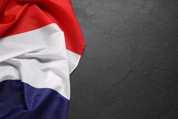 Flag of Netherlands on black background, top view. Space for text