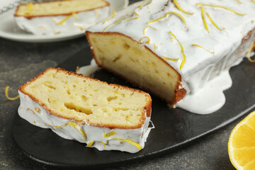 Tasty lemon cake with glaze on table, closeup