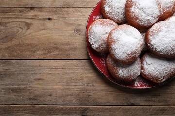 Delicious sweet buns on wooden table, top view. Space for text