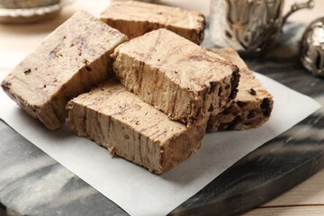 Tasty chocolate halva on wooden table, closeup