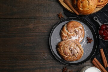 Delicious rolls with sugar powder, berries and spices on wooden table, flat lay with space for text. Sweet buns