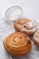Different delicious rolls on light table. Sweet buns