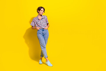 Fototapeta na wymiar Full length photo of stunning lovely person put arms pockets posing empty space information ad isolated on yellow color background