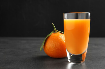 Delicious tangerine liqueur and fresh fruit on grey table, space for text