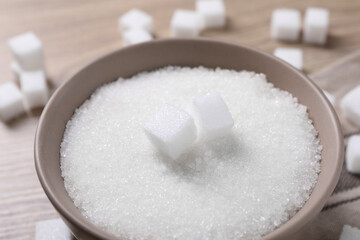 Fototapeta na wymiar Different types of white sugar in bowl on table, closeup