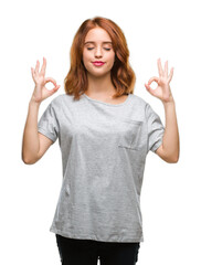 Fototapeta na wymiar Young beautiful woman over isolated background relax and smiling with eyes closed doing meditation gesture with fingers. Yoga concept.