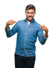 Young handsome man over isolated background looking confident with smile on face, pointing oneself...