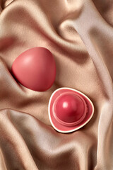 Open Rose-Colored Lip Balm on Silky Fabric - 711431861