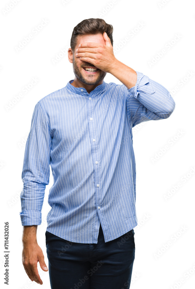 Sticker Young handsome man over isolated background smiling and laughing with hand on face covering eyes for surprise. Blind concept.