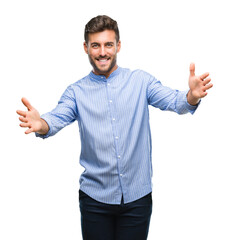 Young handsome man over isolated background looking at the camera smiling with open arms for hug. Cheerful expression embracing happiness.