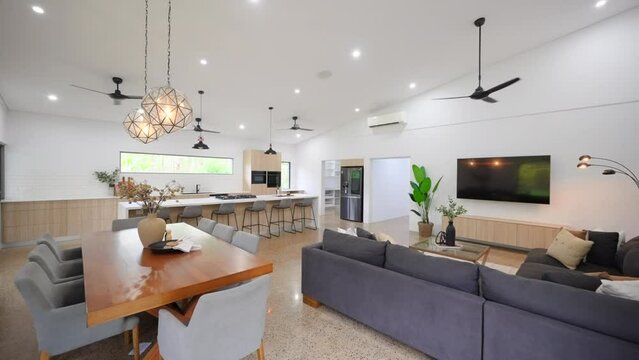 modern stylish architecturally designed large open plan home. Open plan home with large breakfast bar pendant lights simple colour scheme