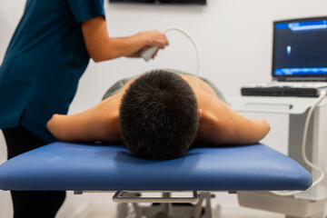 Physiotherapy session with a patient receiving ultrasound therapy