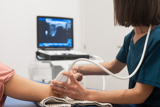 Healthcare professional conducting arm ultrasound exam