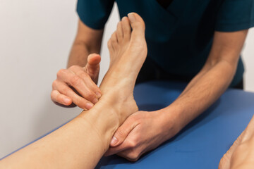 Physical therapist examining a patient's foot