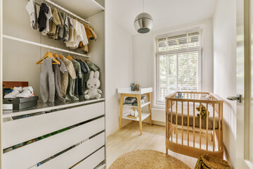 Modern baby room with organized wardrobe and crib