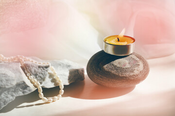Spa salon, Natural Alternative Therapy . Candle and perls on stone - obrazy, fototapety, plakaty