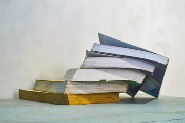 The pile of books collapsed on the table depicts the destruction of education