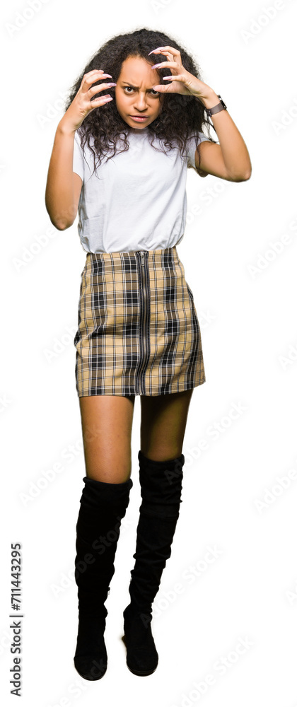 Poster Young beautiful girl with curly hair wearing casual white t-shirt Shouting frustrated with rage, hands trying to strangle, yelling mad