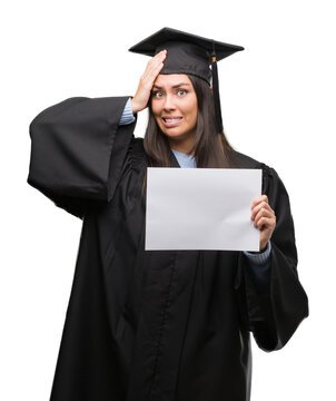Young hispanic woman wearing graduated uniform holding diploma paper stressed with hand on head, shocked with shame and surprise face, angry and frustrated. Fear and upset for mistake.