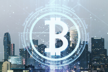 Double exposure of creative Bitcoin symbol hologram on Los Angeles office buildings background. Mining and blockchain concept