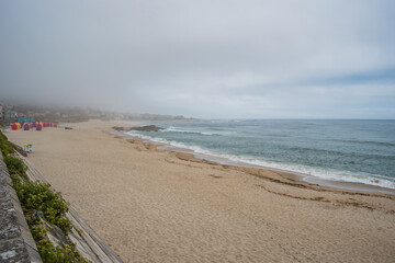 Sand of Moledo beach and fog on the horizon, PORTUGAL