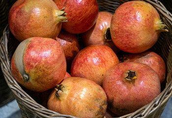 Red pomegranates in a basket at the market.