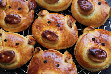 freshly baked golden yellow pretzels with a pig face	
