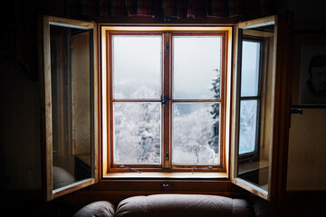 A wonderful foggy view on Beskydy mountains from window of chalet. 
