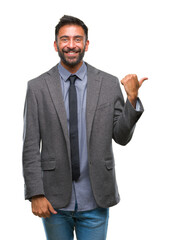 Adult hispanic business man over isolated background smiling with happy face looking and pointing to the side with thumb up.
