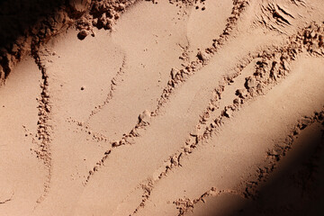Background of brown sandy powder. concept of beauty, texture and cosmetics mock up