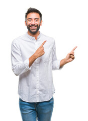 Adult hispanic man over isolated background smiling and looking at the camera pointing with two...