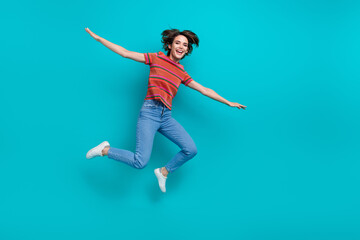 Fototapeta na wymiar Photo of glad positive girl wearing stylish outfit flying air with open hands isolated on cyan color background