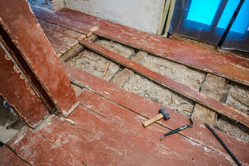 Old wooden floor repairing. Old planks on the floor.