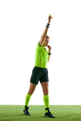 Serious woman, soccer referee gesturing, raising hand, stopping game and showing yellow card as...