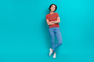 Full length photo of lovely adorable girl with crossed arms wear trendy clothes looking empty space isolated on cyan color background