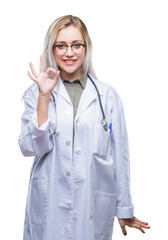 Young blonde doctor woman over isolated background smiling positive doing ok sign with hand and fingers. Successful expression.
