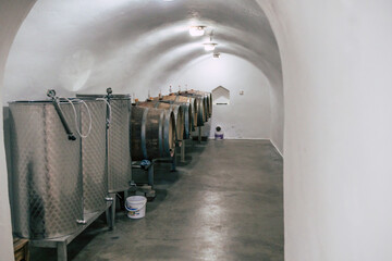 Traditional wine cellars with barrels, casks and stainless steel wine tanks