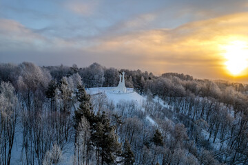 Aerial beautiful winter snowy sunrise view of Vilnius old town, Three Crosses Monument (Trys kryžiai), Lithuania