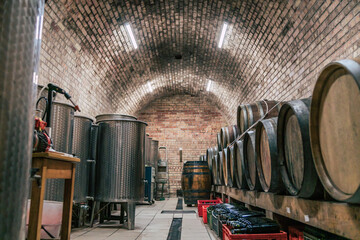 Traditional wine cellars with barrels, casks and stainless steel wine tanks