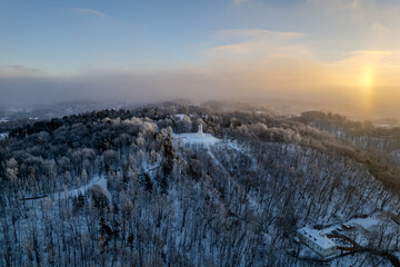Aerial beautiful winter snowy sunrise view of Vilnius old town, Three Crosses Monument (Trys kryžiai), Lithuania