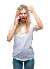 Obraz na płótnie Canvas Young beautiful blonde woman talking using smartphone over isolated background annoyed and frustrated shouting with anger, crazy and yelling with raised hand, anger concept