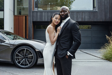 Elegant couple posing with luxury car and home. Generative AI image