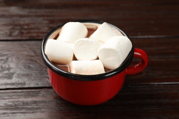 Tasty hot chocolate with marshmallows on wooden table, closeup