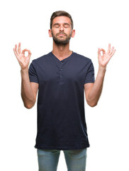 Fototapeta premium Young handsome man over isolated background relax and smiling with eyes closed doing meditation gesture with fingers. Yoga concept.