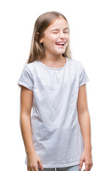 Fototapeta premium Young beautiful girl over isolated background winking looking at the camera with sexy expression, cheerful and happy face.