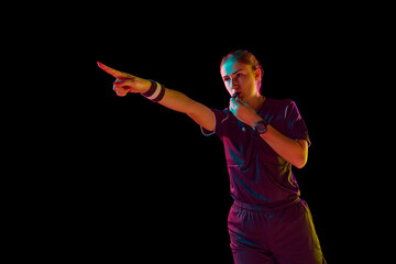 Precision in play. Accuracy of a young female referee on the field, blowing whistle and gesturing...