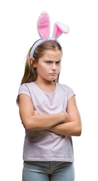 Young beautiful girl wearing easter bunny ears over isolated background skeptic and nervous, disapproving expression on face with crossed arms. Negative person.