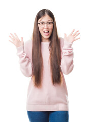 Young Chinese woman over isolated background wearing glasses celebrating crazy and amazed for success with arms raised and open eyes screaming excited. Winner concept