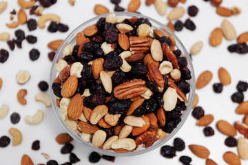 top view of mixed nuts in a bowl on a white